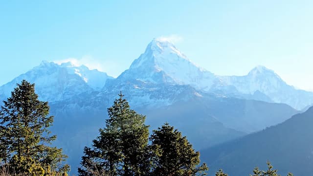 Photographer at Poon Hill sunrise Nepal Annapurna range golden hour 2026