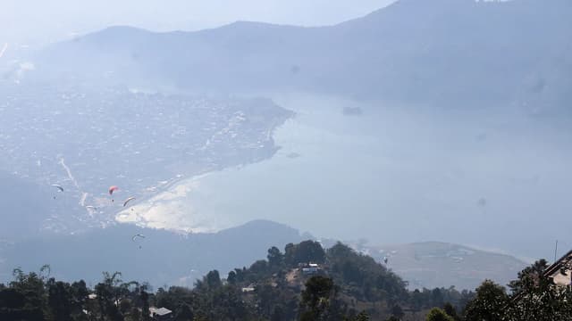 Tandem paraglider over Phewa Lake Pokhara with Annapurna mountains
