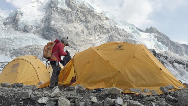 Trekkers on the Everest Base Camp trail in Nepal with Himalayan peaks behind — the classic trek for US travelers in 2026