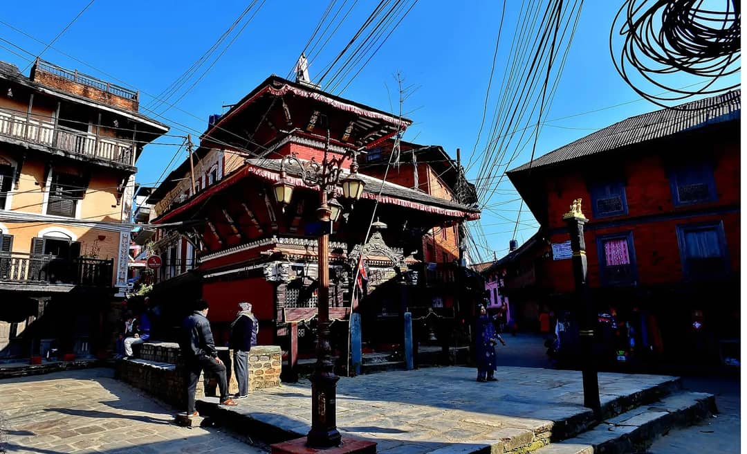 The red-brick, two-tiered Bindabasini temple on Bandipur's stone-paved bazaar square, with old Newar houses around it