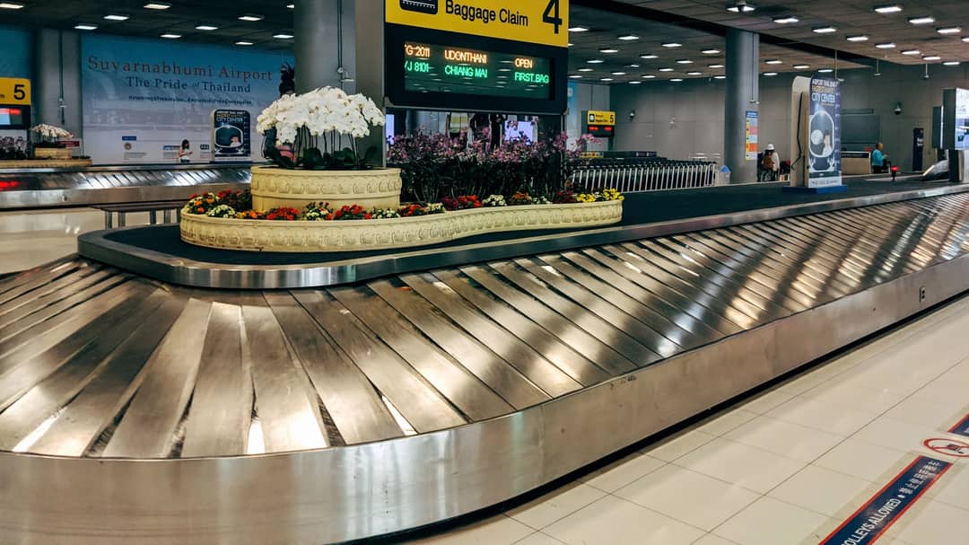 A baggage claim carousel in an airport arrivals hall