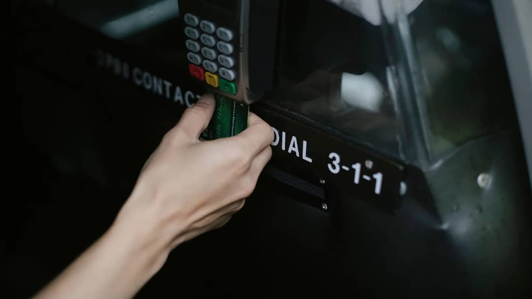 A traveller paying for a taxi ride with a card on a card machine