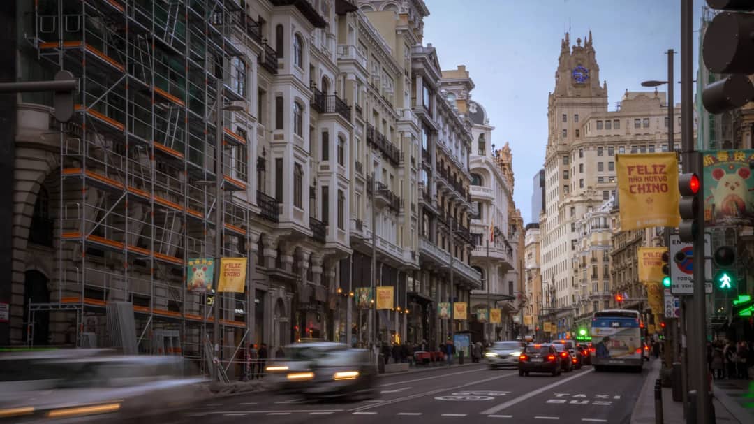 Traffic on Gran Vía in Madrid, Spain, with the Telefónica Building behind