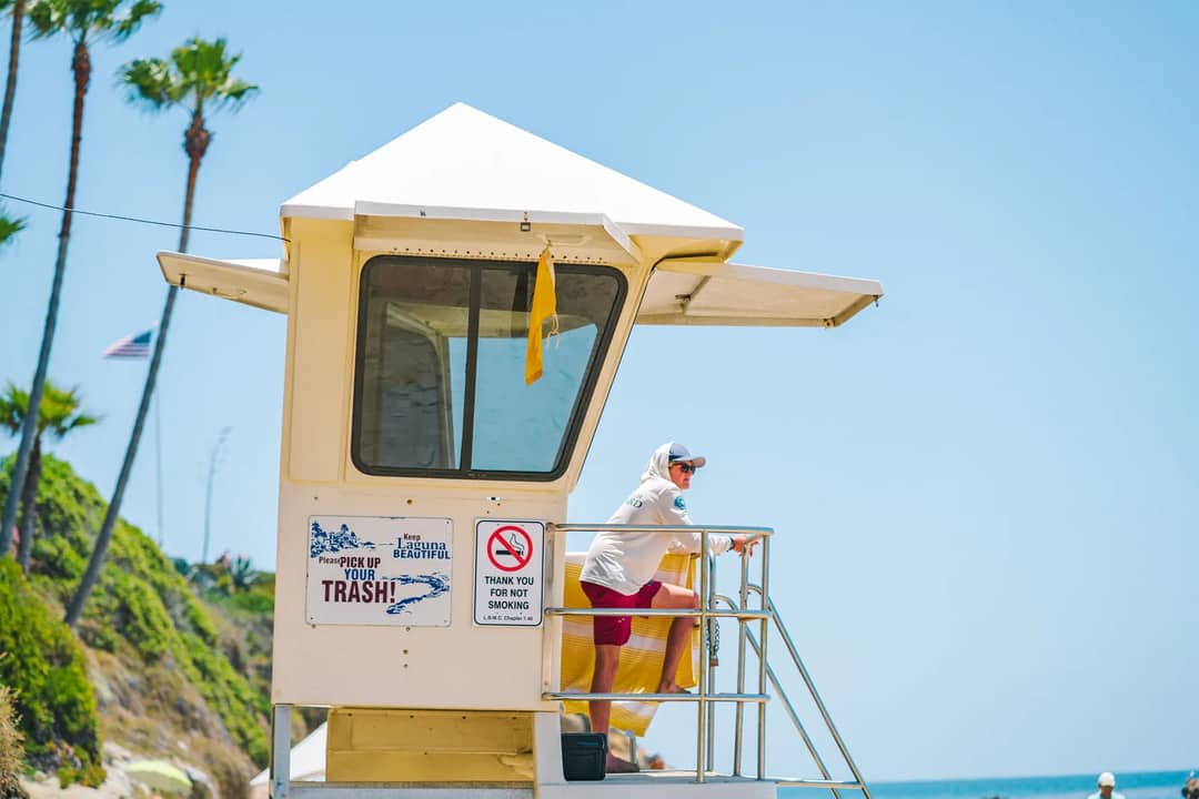 A lifeguard watching over a sunny beach from a tower