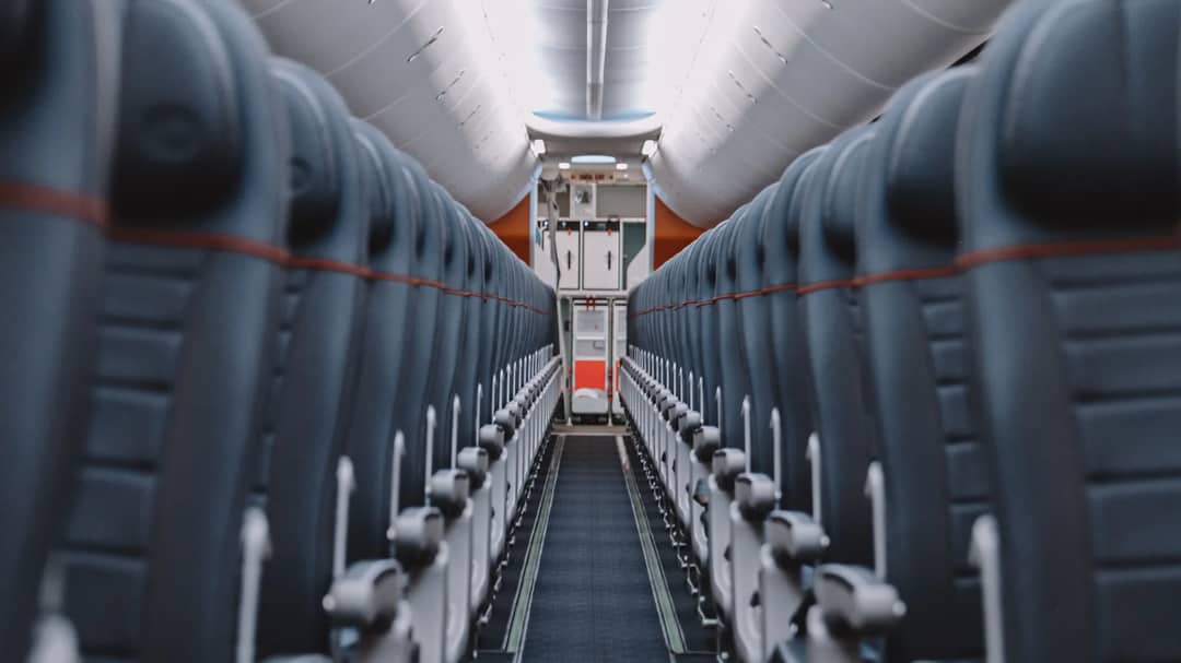 The aisle of an empty airplane cabin
