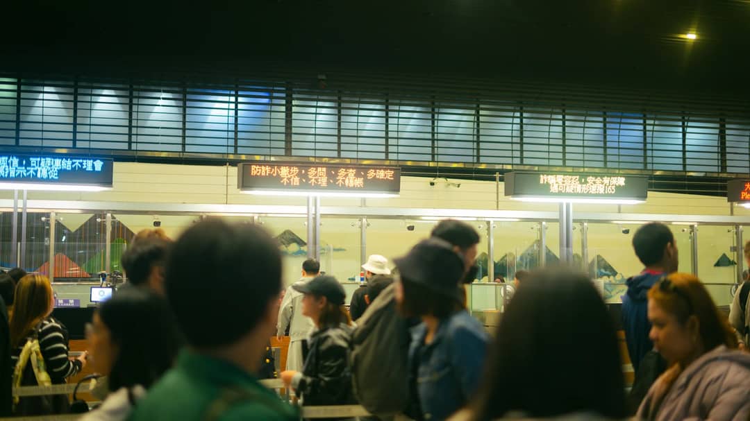 Travellers queueing at an airport check-in hall
