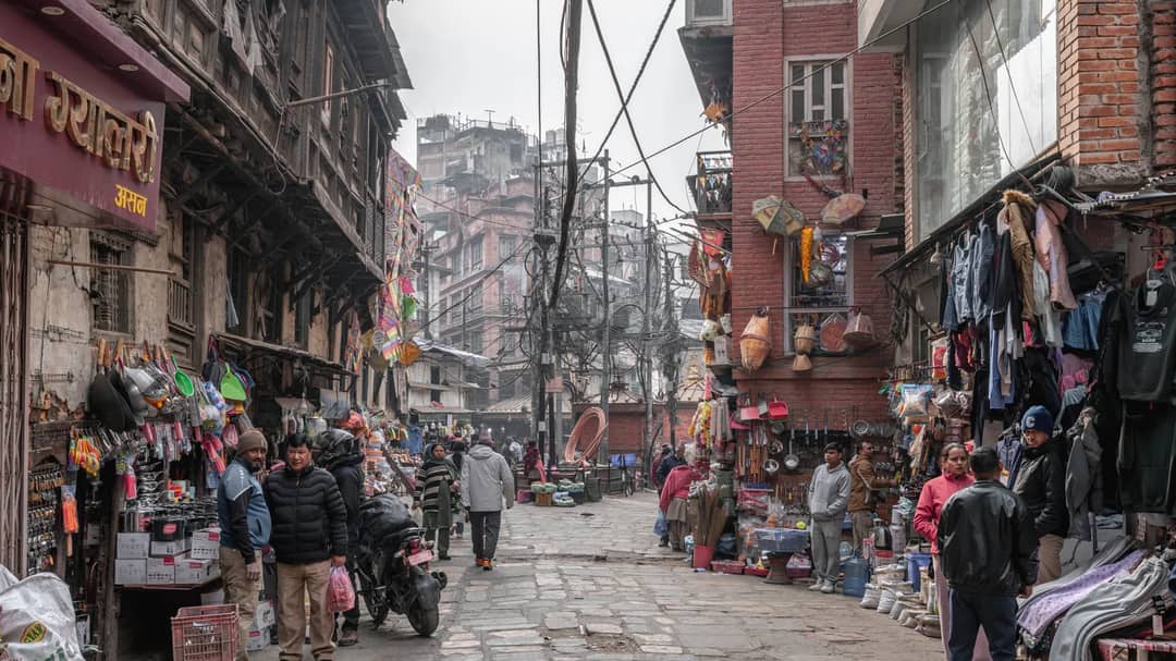 A busy market street in Kathmandu, Nepal, with vendors and shoppers