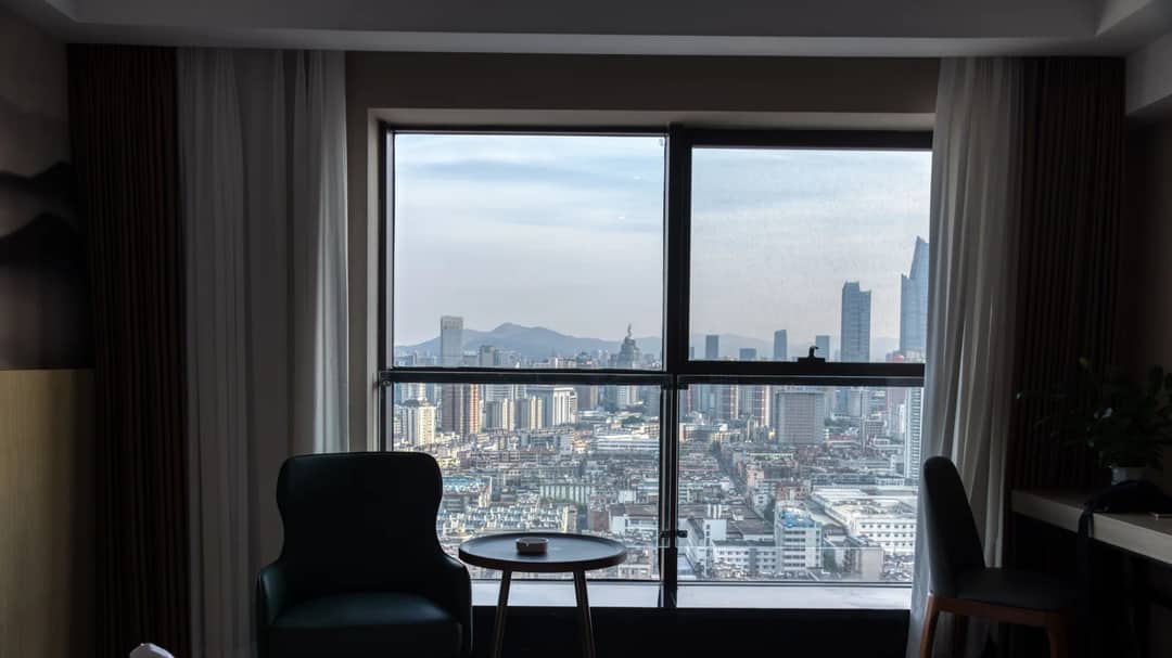 A city skyline seen from a hotel room window
