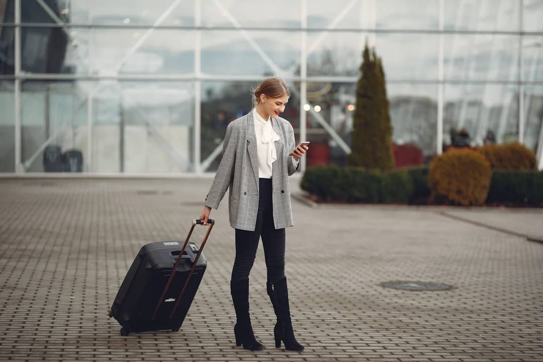 A traveller checking a phone at the airport