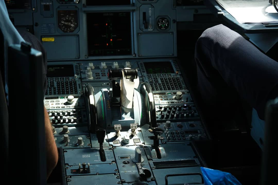 Detailed view of an airplane cockpit showcasing control panel and levers.