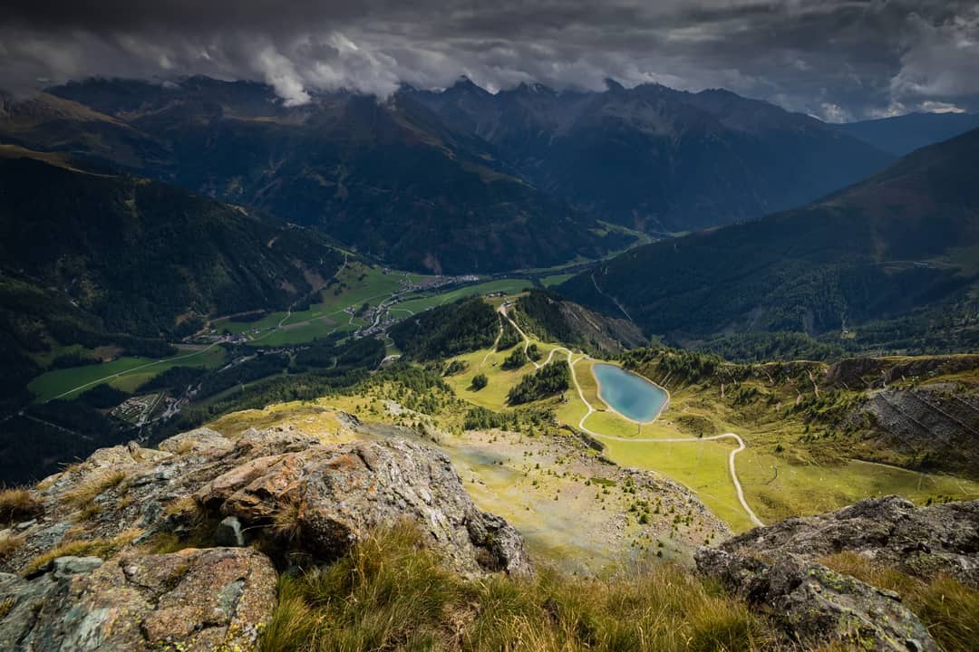 Stunning aerial view of Kals am Großglockner, Tyrol with dramatic clouds and mountain vistas.