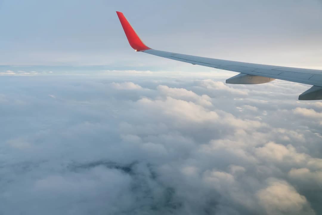 The view from an aircraft window above the clouds