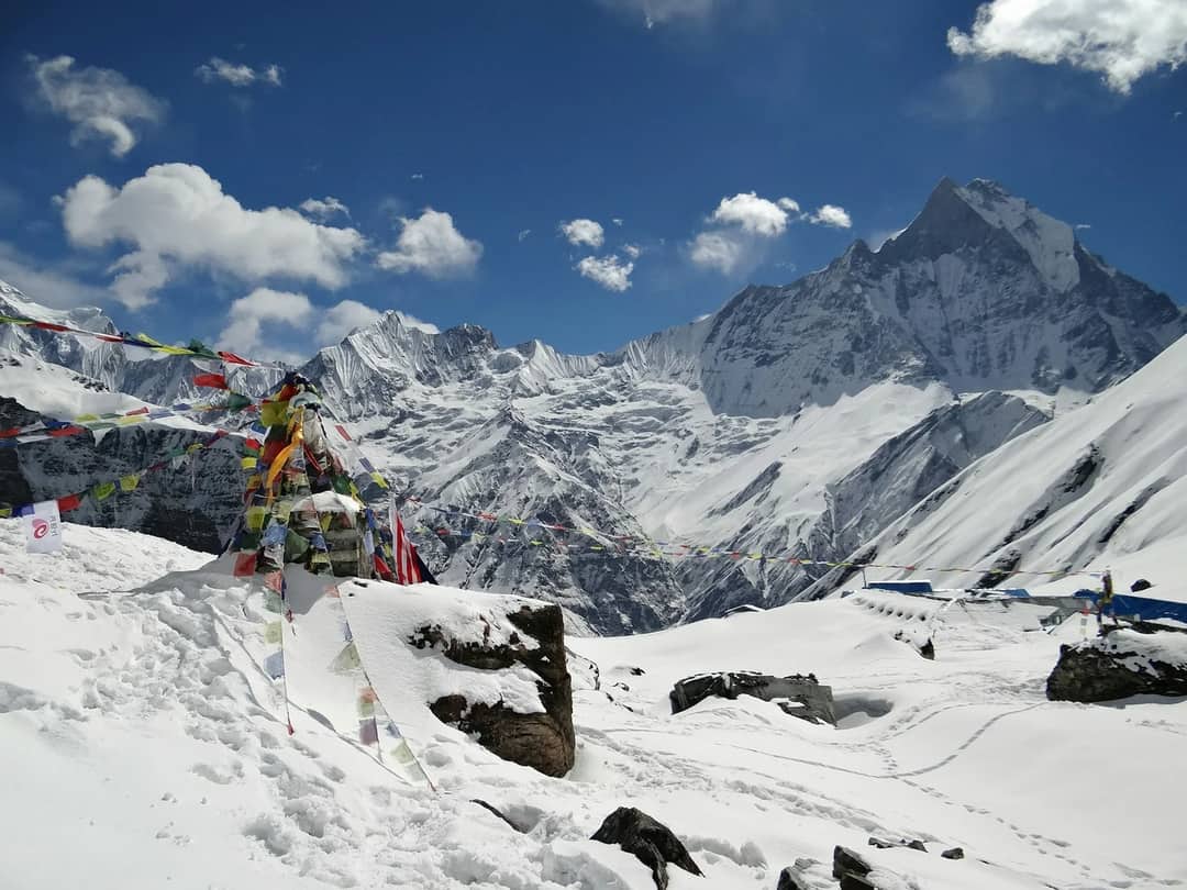 a mountain covered in snow under a blue sky