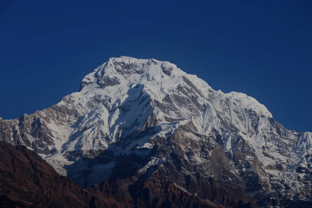 Capture the stunning snow-covered Annapurna mountain peak in Ghandruk, Nepal.