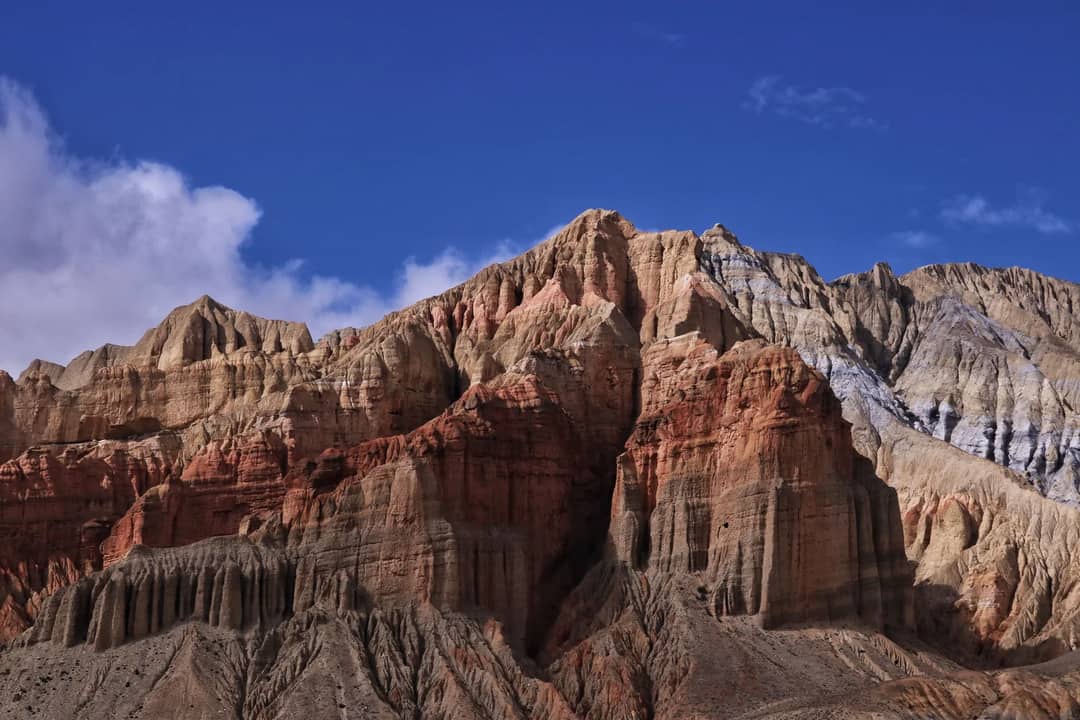 Breathtaking rock formations under a blue sky in Lo Manthang, Nepal.