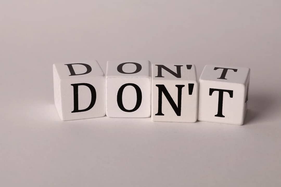 Text cubes spelling 'DON'T' on a clean white background, ideal for concepts of caution or prohibition.