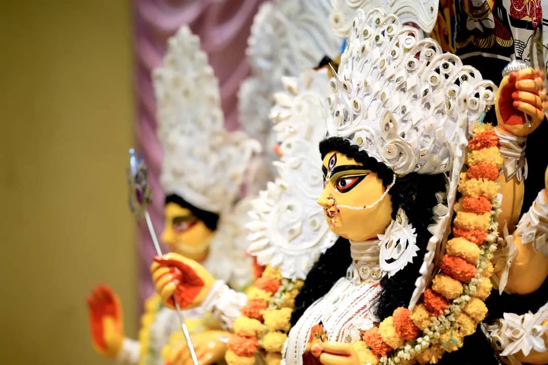 Beautifully crafted Durga idol adorned with intricate details at a Kolkata Durga Puja pandal.