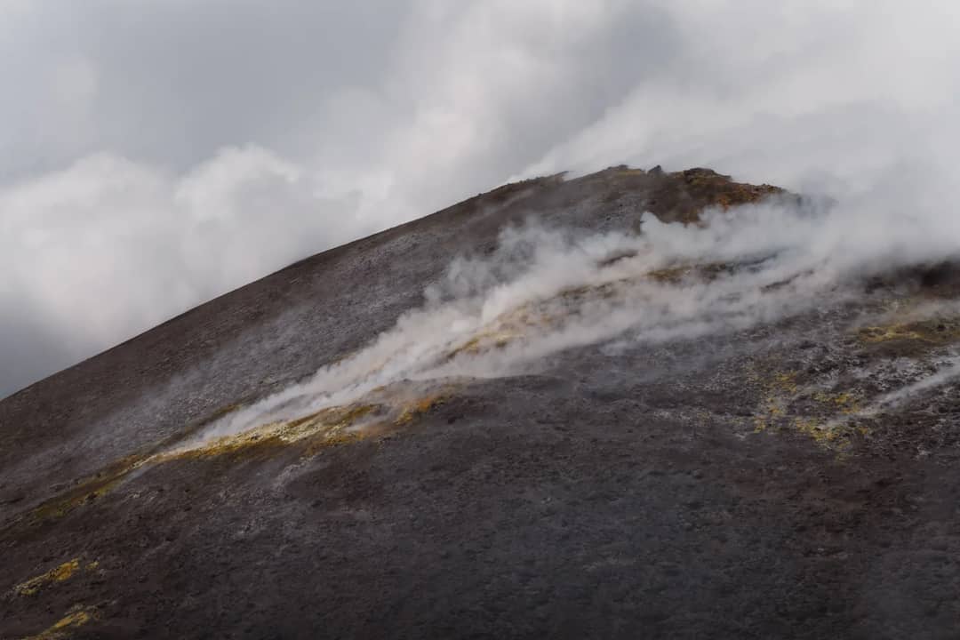 Steam rises from the volcanic slope of Mount Etna in Sicily.