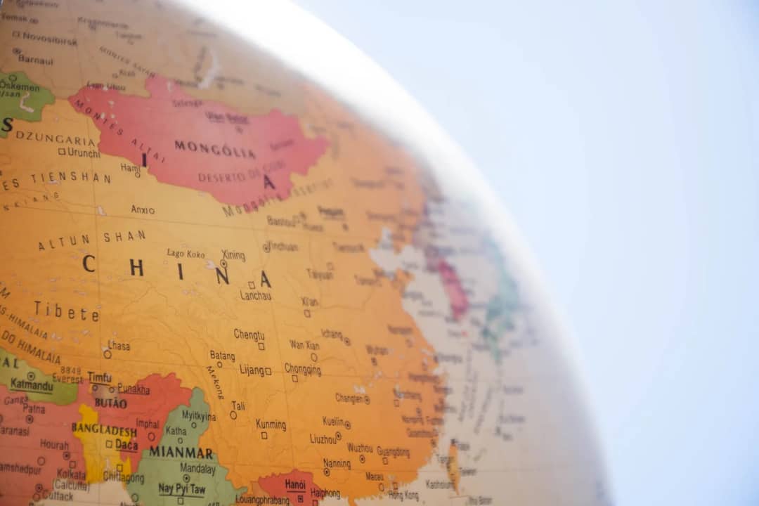 Detailed close-up of a globe showing China and surrounding regions, with geographic labels in focus.