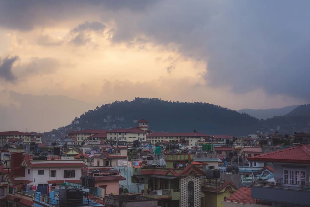 A hillside town under an evening sky