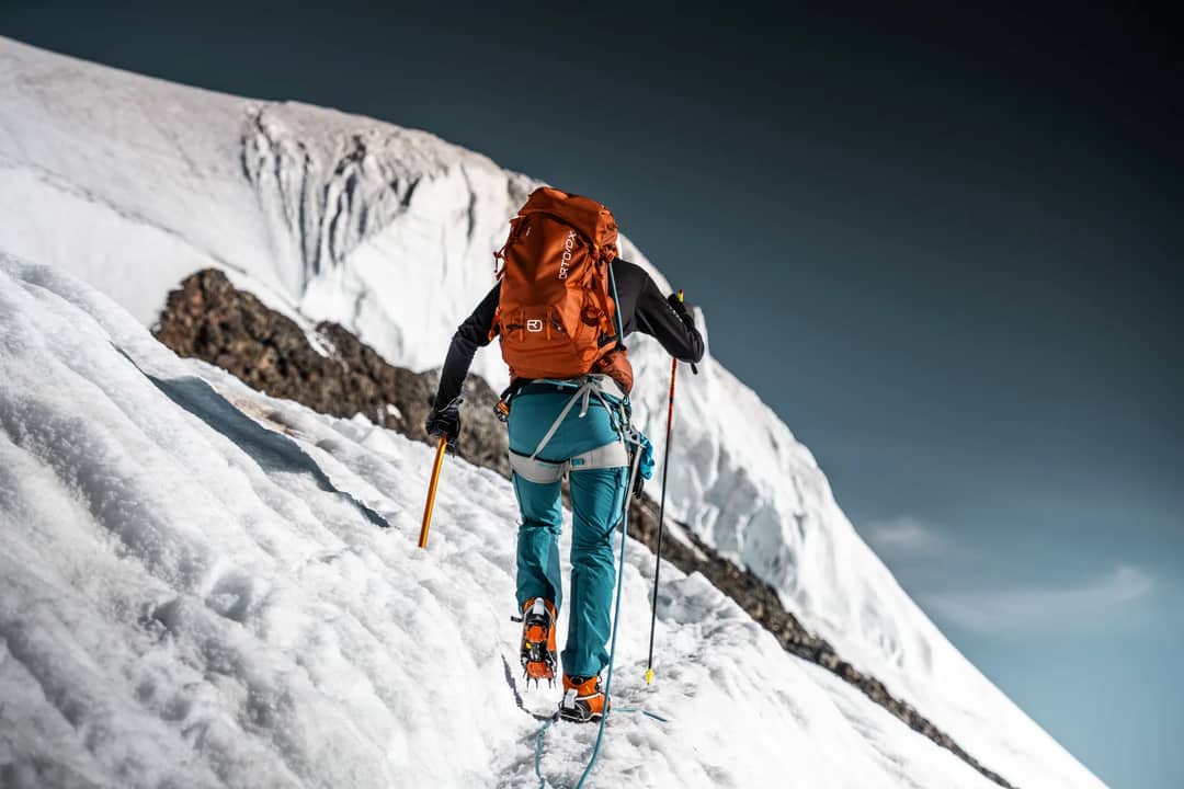 A determined climber ascends a snowy slope in Zermatt, Switzerland, showcasing adventure and resilience.