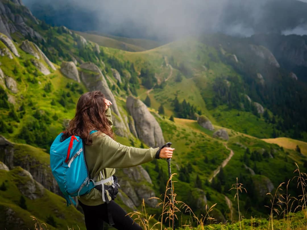 A hiker looking out over a mountain valley