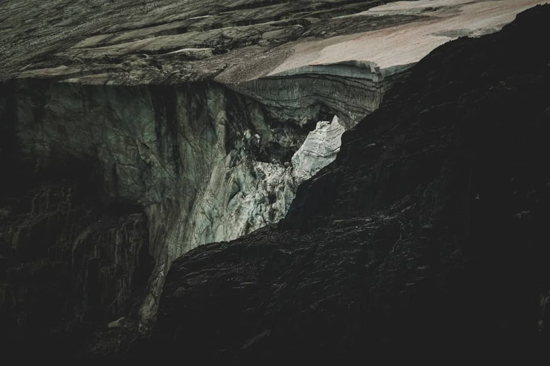 Dramatic dark rock and ice formation, showcasing geological beauty and texture.
