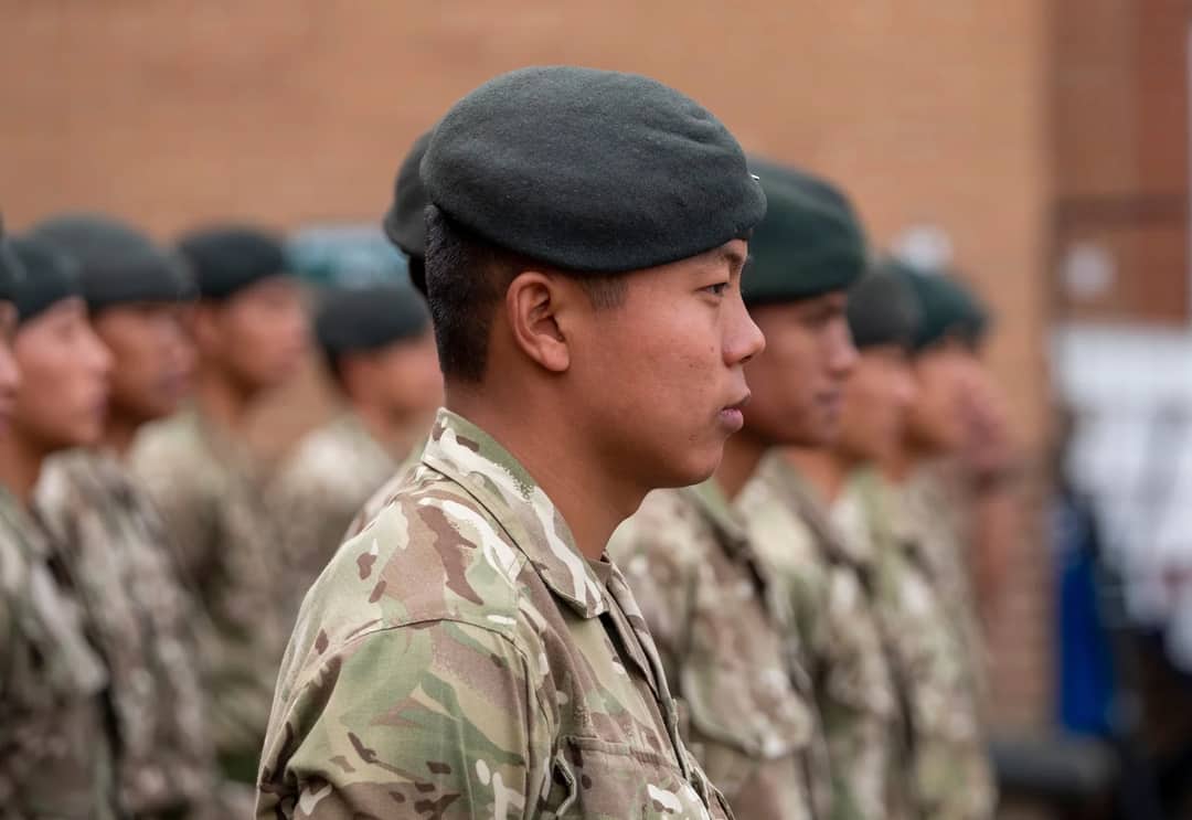A side view of Gurkha soldiers in uniform standing in formation at Catterick, UK.