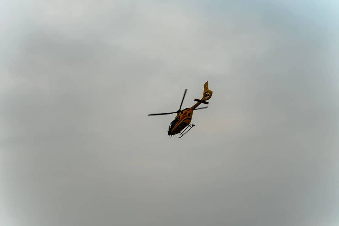 Aerial view of a helicopter flying over a cloudy sky in Brzegi, Małopolska, Poland.