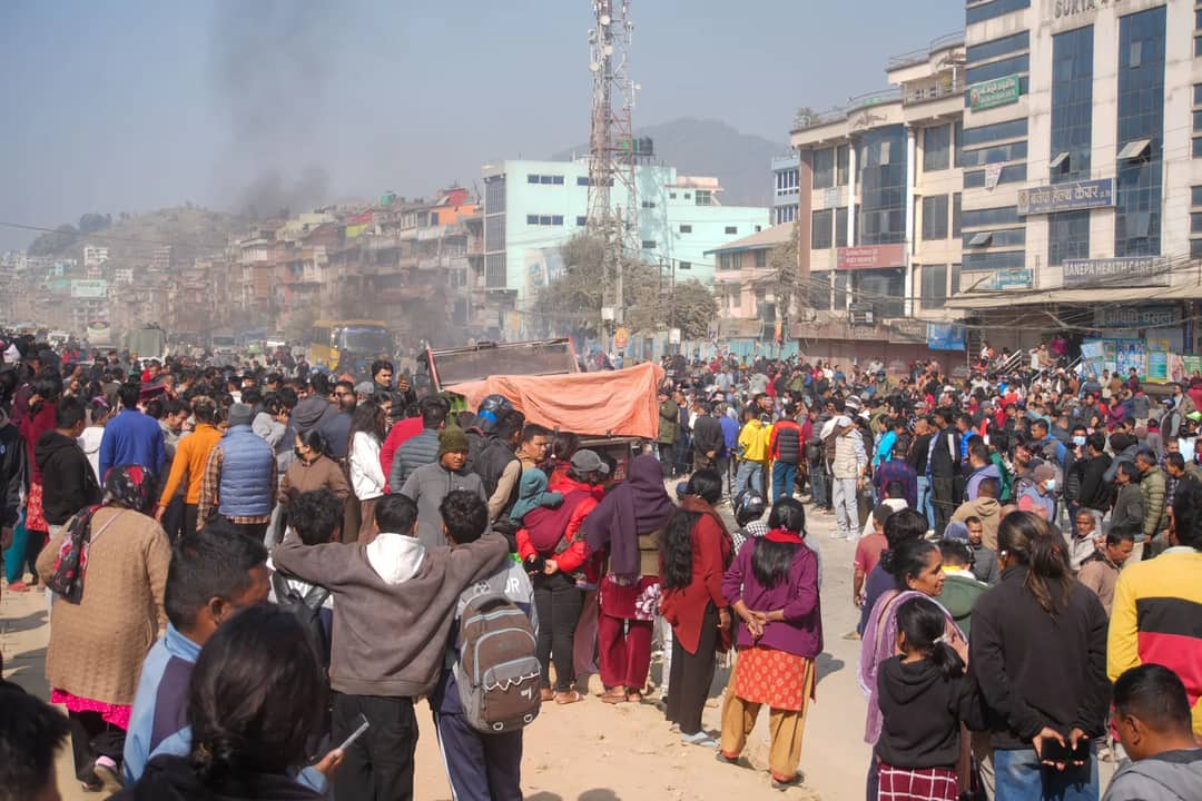 A bustling street with a large crowd gathered in an urban area, showcasing vibrant community life.