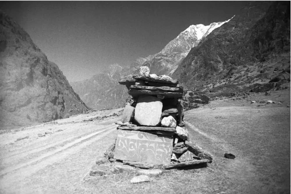 A mani stone chorten beside the Langtang trail with a snow peak behind, 1999