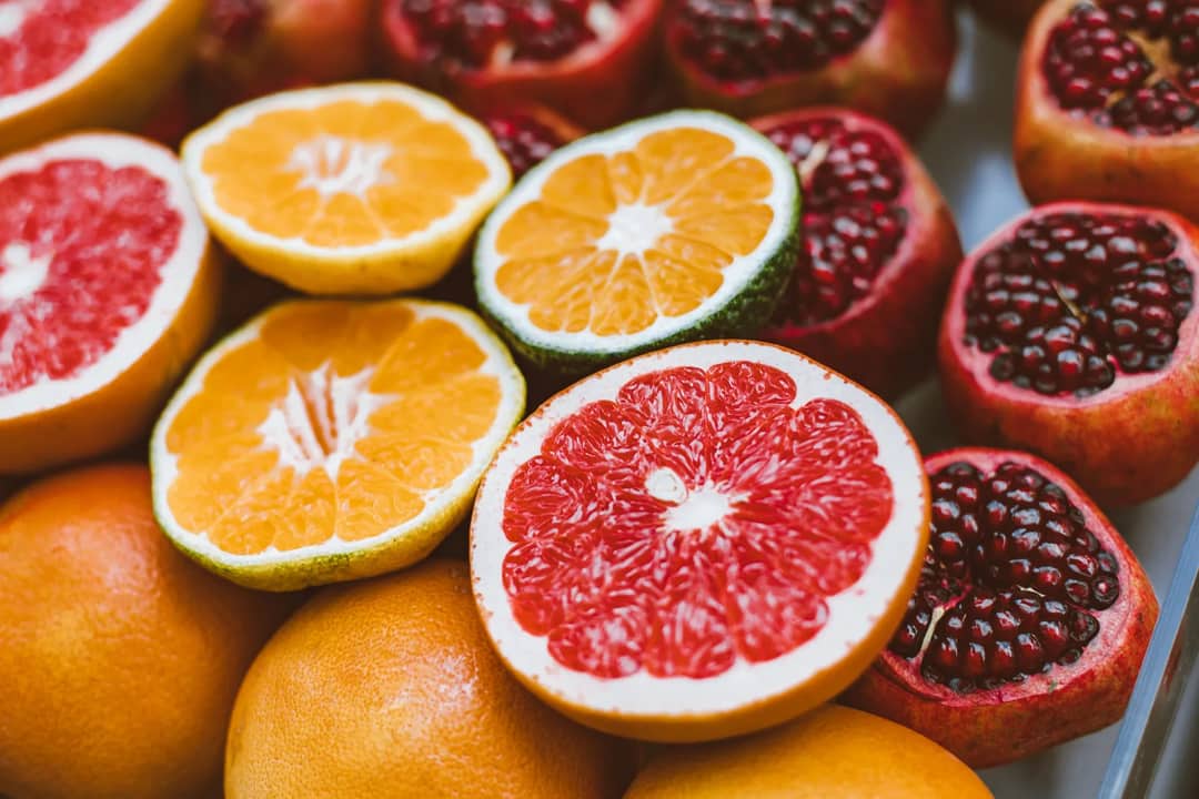 Vibrant close-up of sliced citrus fruits and pomegranates showcasing freshness and variety.