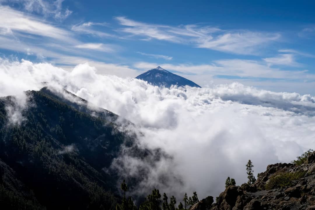 Majestic view of Mount Teide surrounded by clouds in the Canary Islands.