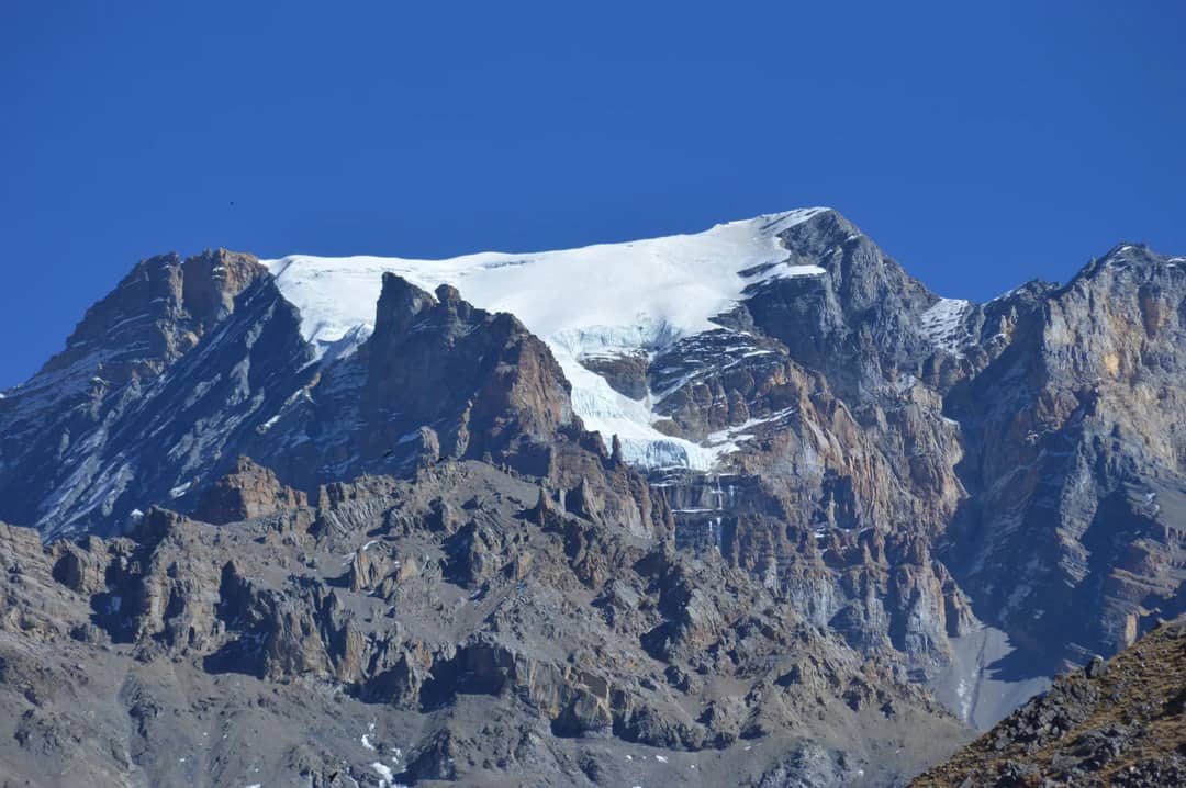 Breathtaking view of the Himalayan mountains in Ghandruk, Nepal under a clear blue sky.