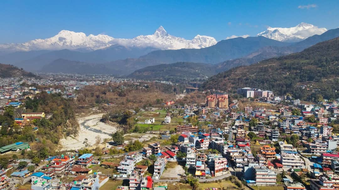 Stunning aerial view of Pokhara, Nepal with Machhapuchhre and the Himalayas in the background.