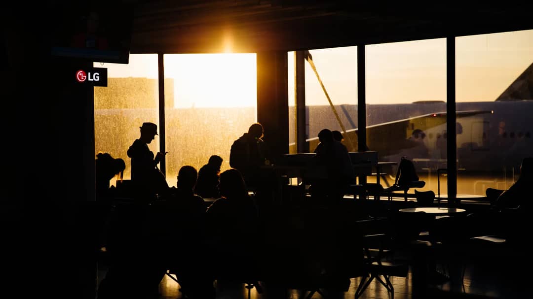 Passengers waiting at an airport departure gate