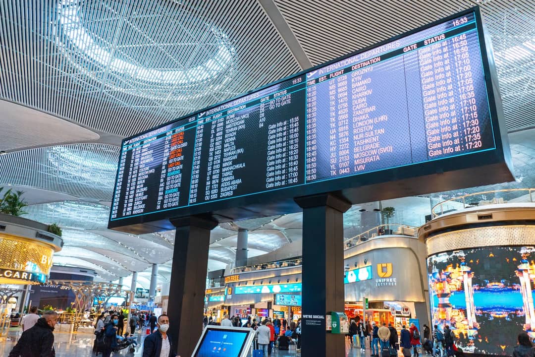 A flight information board in an airport terminal