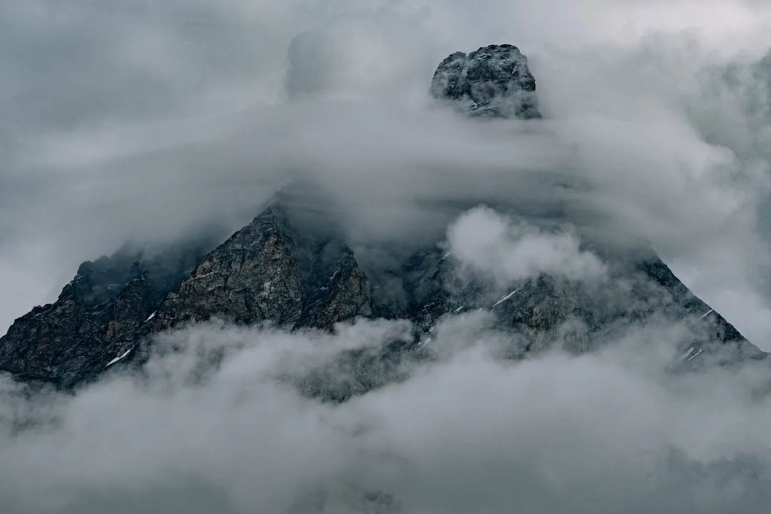 A rocky mountain summit wrapped in cloud