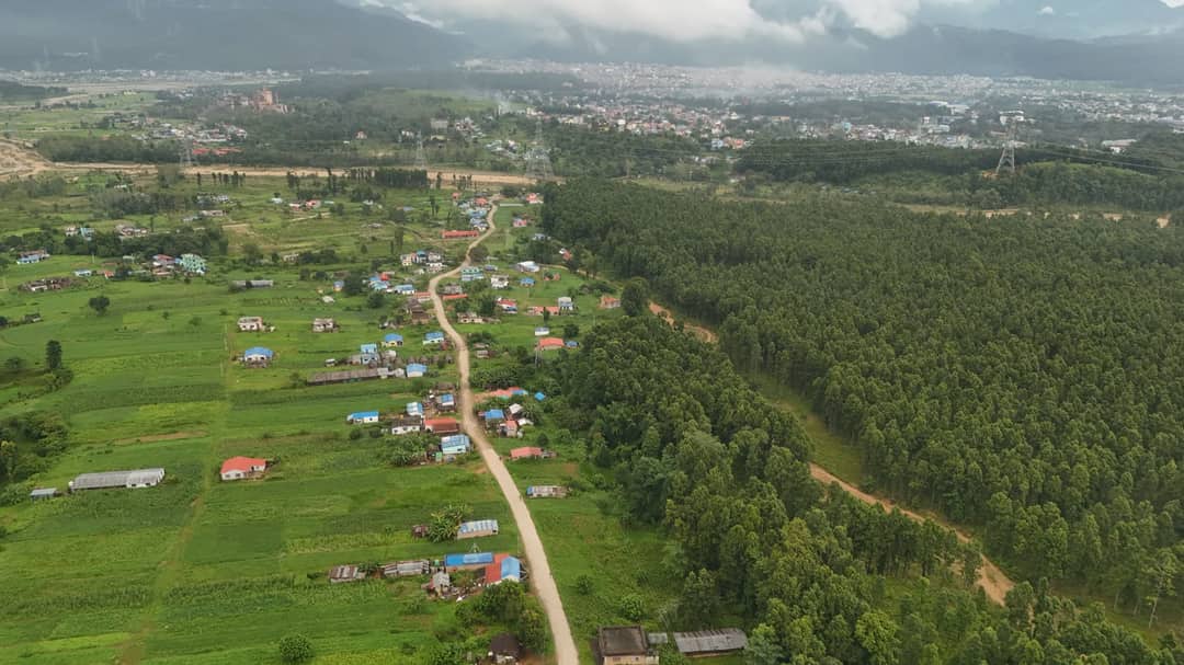 Scenic aerial view of rural Nepal with lush greenery and small villages.