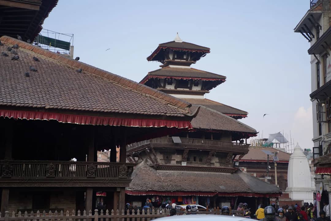 A bustling scene at a traditional pagoda temple in Kathmandu, Nepal, showcasing intricate architecture.