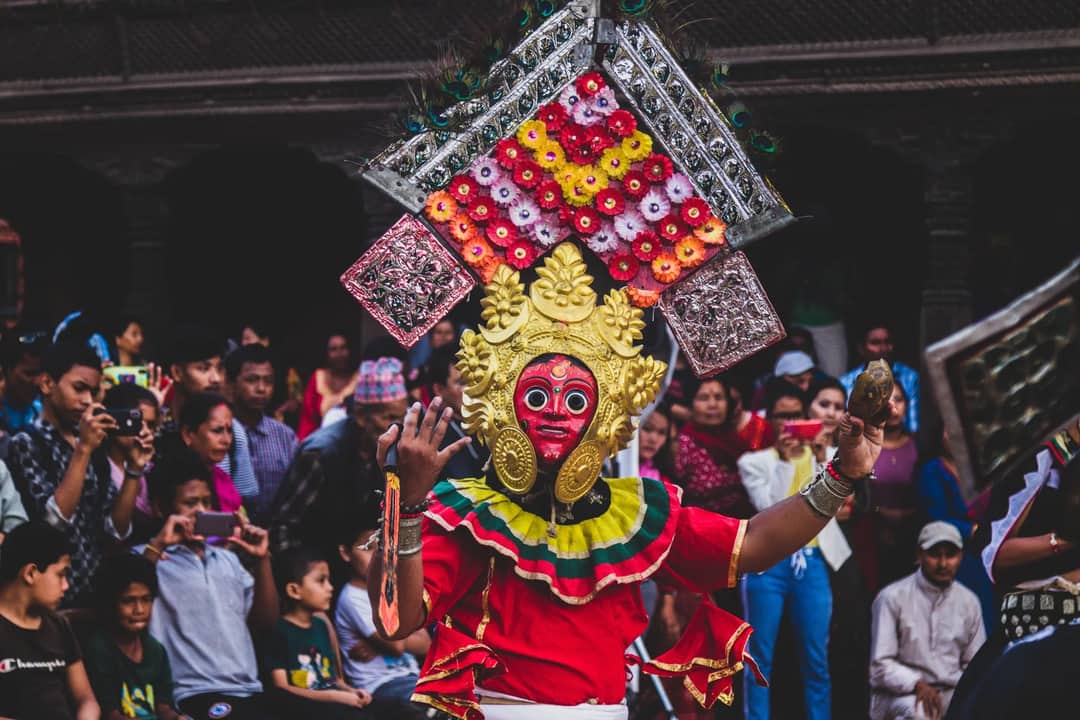 Colorful traditional masked dance performance in Bhaktapur, Nepal, captivating the audience during a vibrant festival.