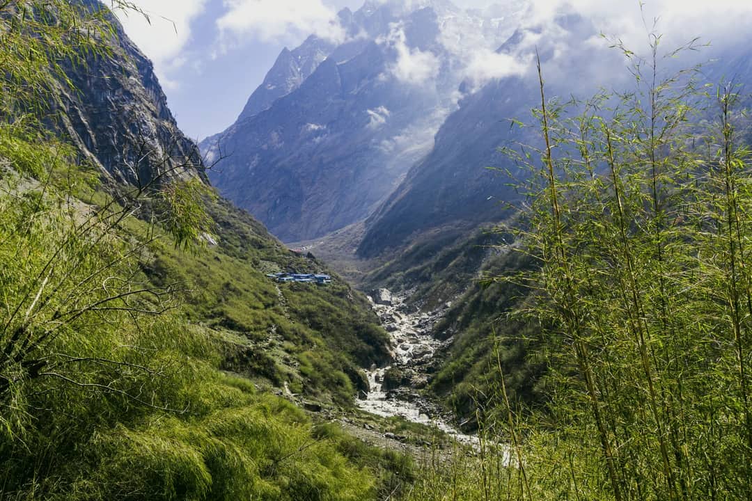 Explore the breathtaking Annapurna landscape with towering mountains and lush greenery.