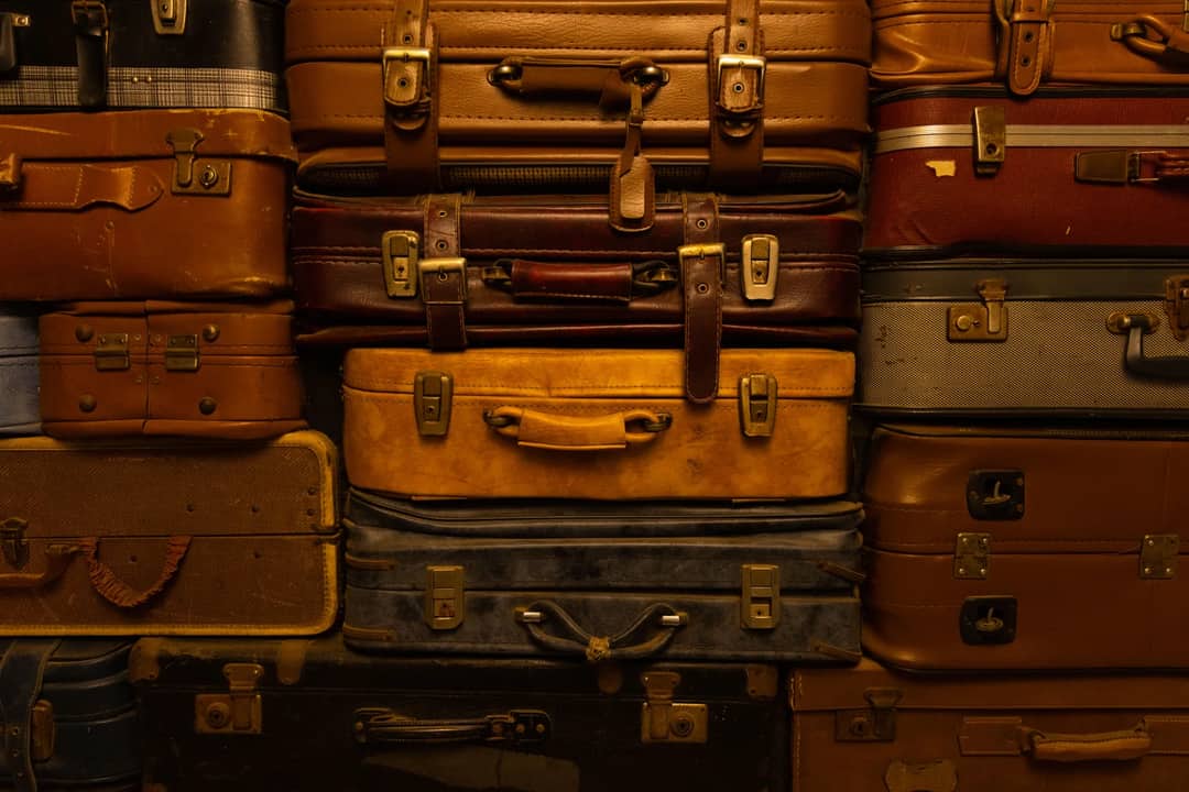 Vintage leather suitcases stacked in a pile — luggage has changed a great deal since; the buyer’s question has not