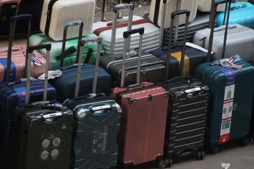 Rows of cabin-sized wheeled cases with their handles up — what counts as carry-on is set by the airline, not by the bag