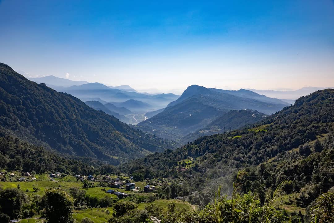 Scenic view of the Himalayan mountains with lush valleys and clear skies in Nepal.