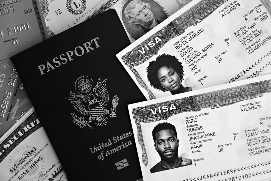 A close-up of US passport with visas and currency, implying travel theme.