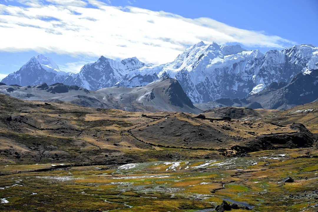 Breathtaking panorama of snow-covered peaks in the Andes with expansive highland terrain.