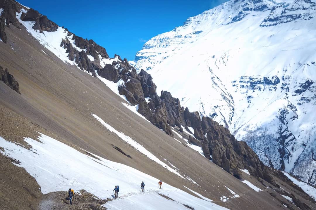 Climbers on a snow ridge in the Himalaya
