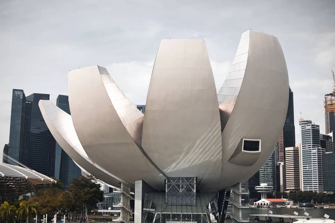 Iconic ArtScience Museum in Singapore with a backdrop of modern skyscrapers.