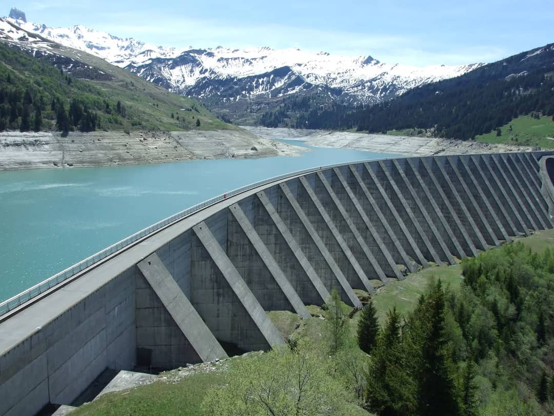 A dam holding back an alpine lake